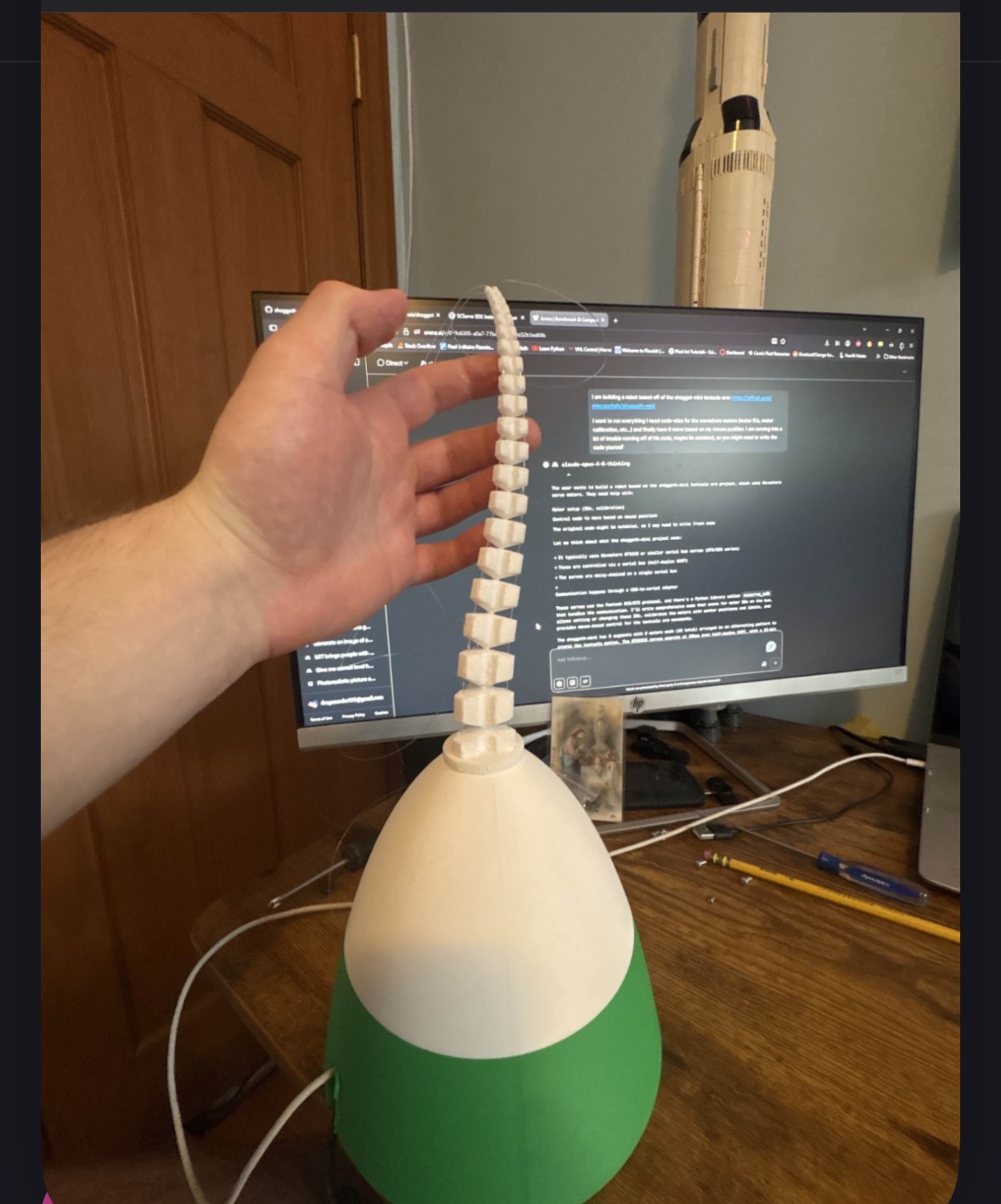 Early segmented soft-arm prototype with a green and white base